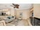 Inviting living room with fireplace, ceiling fan, and view of the kitchen at 8809 Havenridge Dr, Sarasota, FL 34238