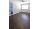 Spacious bedroom with dark wood flooring and an ensuite bathroom at 10265 Gandy N Blvd # 1415, St Petersburg, FL 33702