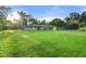 Spacious front yard with lush lawn and mature trees at 3740 Aberdeen Dr, Sarasota, FL 34240