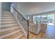 Wooden staircase with metal railing leading to the second floor at 7121 Estero Ct, Apollo Beach, FL 33572