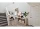 Bright foyer with stairs, table decor, and luxury vinyl plank flooring at 16896 Fiesta Dr, Port Charlotte, FL 33953