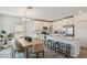 Bright kitchen and dining area with white cabinetry and island seating at 16896 Fiesta Dr, Port Charlotte, FL 33953