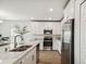 Bright kitchen features white cabinets, stainless appliances, and marble countertops at 16896 Fiesta Dr, Port Charlotte, FL 33953