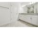 Bathroom featuring a double sink vanity with granite countertops, white cabinets, and tiled floors at 18063 Cherished Loop, Bradenton, FL 34211