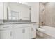 Bathroom featuring a vanity with granite counters, a tile shower, and toilet at 18063 Cherished Loop, Bradenton, FL 34211