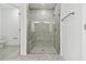Bathroom featuring a large glass door shower with bench and tiled walls and floor at 18063 Cherished Loop, Bradenton, FL 34211