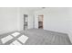 Carpeted bedroom with a door to a bathroom at 18063 Cherished Loop, Bradenton, FL 34211