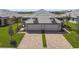 New villa with a large driveway, two car garage and a well manicured lawn at 18063 Cherished Loop, Bradenton, FL 34211