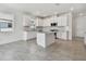 Bright kitchen features white cabinets, granite countertops, and a large island at 18063 Cherished Loop, Bradenton, FL 34211