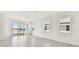 Bright living room with tiled floors, large windows, and a view of the lake at 18063 Cherished Loop, Bradenton, FL 34211