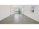Bright living room with tiled floors, large sliding glass doors, and a view of the lake at 18063 Cherished Loop, Bradenton, FL 34211