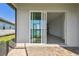 Screened-in lanai with a sliding glass door and patio with decorative brick flooring at 18063 Cherished Loop, Bradenton, FL 34211