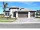 Beautiful one-story home with a three-car garage, well-manicured lawn, and elegant paved driveway at 2036 Bolsena St, Nokomis, FL 34275