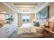 Bright bedroom with tray ceiling, decorative lighting, stylish decor, and a view to the outside at 2036 Bolsena St, Nokomis, FL 34275