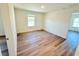 A clean bedroom with neutral paint, a double-hung window, and wood-look flooring at 7971 Chandler Lake Ct, Hudson, FL 34667