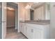 Contemporary bathroom with double sink vanity, granite countertops, white cabinets and tile floors at 17126 Savory Mist Cir, Bradenton, FL 34211
