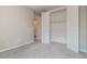 A clean bedroom with neutral paint, carpet floor, and open closet, offering versatility at 17126 Savory Mist Cir, Bradenton, FL 34211