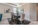 Dining room features hardwood floors, modern lighting fixture, neutral paint, and large area rug at 17126 Savory Mist Cir, Bradenton, FL 34211