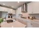 A bright and modern kitchen with white cabinets, stainless steel appliances, and quartz countertops at 17126 Savory Mist Cir, Bradenton, FL 34211
