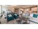 An open-concept living room and kitchen area featuring hardwood floors, modern lighting, and stainless steel appliances at 17126 Savory Mist Cir, Bradenton, FL 34211