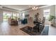 Sun-filled living room and dining area with modern furniture, neutral paint, and large sliding glass doors at 17126 Savory Mist Cir, Bradenton, FL 34211