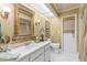 Elegant bathroom with a framed mirror, decorative sconces, and a tiled floor at 1336 Roosevelt Dr, Venice, FL 34293