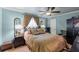 Bedroom with a decorative upholstered bed frame, bedside tables, and a ceiling fan at 1336 Roosevelt Dr, Venice, FL 34293
