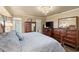 Bright bedroom featuring neutral walls, a decorative chandelier, and warm wood accents at 1336 Roosevelt Dr, Venice, FL 34293