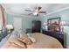 Comfortable bedroom showcases soothing light blue walls, a ceiling fan, and a decorative dresser at 1336 Roosevelt Dr, Venice, FL 34293