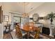 Charming dining room featuring a wooden table, stylish chandelier, and natural light flowing in from the lanai at 1336 Roosevelt Dr, Venice, FL 34293