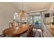 Elegant dining room features a wooden table, chandelier, and sliding glass doors to the outdoor patio at 1336 Roosevelt Dr, Venice, FL 34293