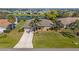 Beautiful home with a manicured lawn and palm trees, near a picturesque pond at 1336 Roosevelt Dr, Venice, FL 34293