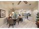 Breakfast nook and kitchen featuring an island with seating, stainless appliances, and access to the lanai at 1336 Roosevelt Dr, Venice, FL 34293