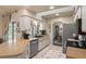 Well-lit kitchen with stainless steel appliances, bright countertop space, and an easy flow to the dining area at 1336 Roosevelt Dr, Venice, FL 34293