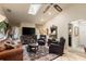 Comfortable living room with a ceiling fan, skylight, and a large TV for relaxation and entertainment at 1336 Roosevelt Dr, Venice, FL 34293