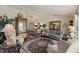 Open-concept living room with dining area, hardwood floors, plush seating, and elegant decor at 1336 Roosevelt Dr, Venice, FL 34293