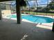 A screened-in pool area provides a serene retreat with a pool, patio, and views of the surrounding landscape at 1336 Roosevelt Dr, Venice, FL 34293