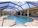 Inviting screened-in pool with ample space for relaxation and recreation on a sunny day at 1336 Roosevelt Dr, Venice, FL 34293