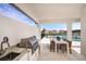 Inviting outdoor kitchen and dining area featuring a stainless grill and serene pool views for entertaining at 1741 Lugano Cir, Nokomis, FL 34275
