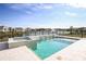 Sparkling pool and spa with elegant tilework and a serene lake view creates a backyard paradise at 1741 Lugano Cir, Nokomis, FL 34275