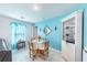 Bright dining area featuring a round table and a blue accent wall with elegant decor at 18149 Dillon Ave, Port Charlotte, FL 33954