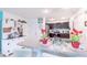 An open-concept kitchen with breakfast bar seating and modern appliances creating a functional space at 18149 Dillon Ave, Port Charlotte, FL 33954