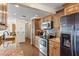 Well lit kitchen featuring stainless steel appliances, granite countertops, and wood flooring at 2241 Blackwood Dr, Venice, FL 34293