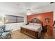 Well lit main bedroom with a decorative headboard, stylish bedding, and a chair at 2241 Blackwood Dr, Venice, FL 34293