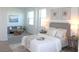 Stylishly furnished bedroom with neutral tones, decorative wall art, and a comfortable seating area at 229 Vistera Blvd, North Venice, FL 34275