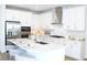 Bright kitchen with a large island, stainless steel appliances, white cabinets, and a subway tile backsplash at 229 Vistera Blvd, North Venice, FL 34275