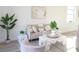 Bright living room with neutral furniture, elegant decor, and a leafy green plant accenting the light space at 229 Vistera Blvd, North Venice, FL 34275