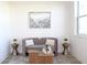 Cozy sitting area with a grey sofa, natural light, decorative art and wood flooring at 229 Vistera Blvd, North Venice, FL 34275