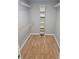 Walk-in closet featuring custom shelving and wood flooring at 23607 Forest View Dr, Land O Lakes, FL 34639