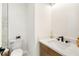 Stylish half-bathroom featuring elegant fixtures, a quartz countertop, and modern vanity at 3508 E 11Th Ave, Tampa, FL 33605